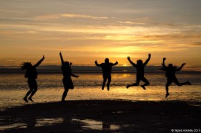 Jumping at sunrise on the Salt Flats, Bolivia